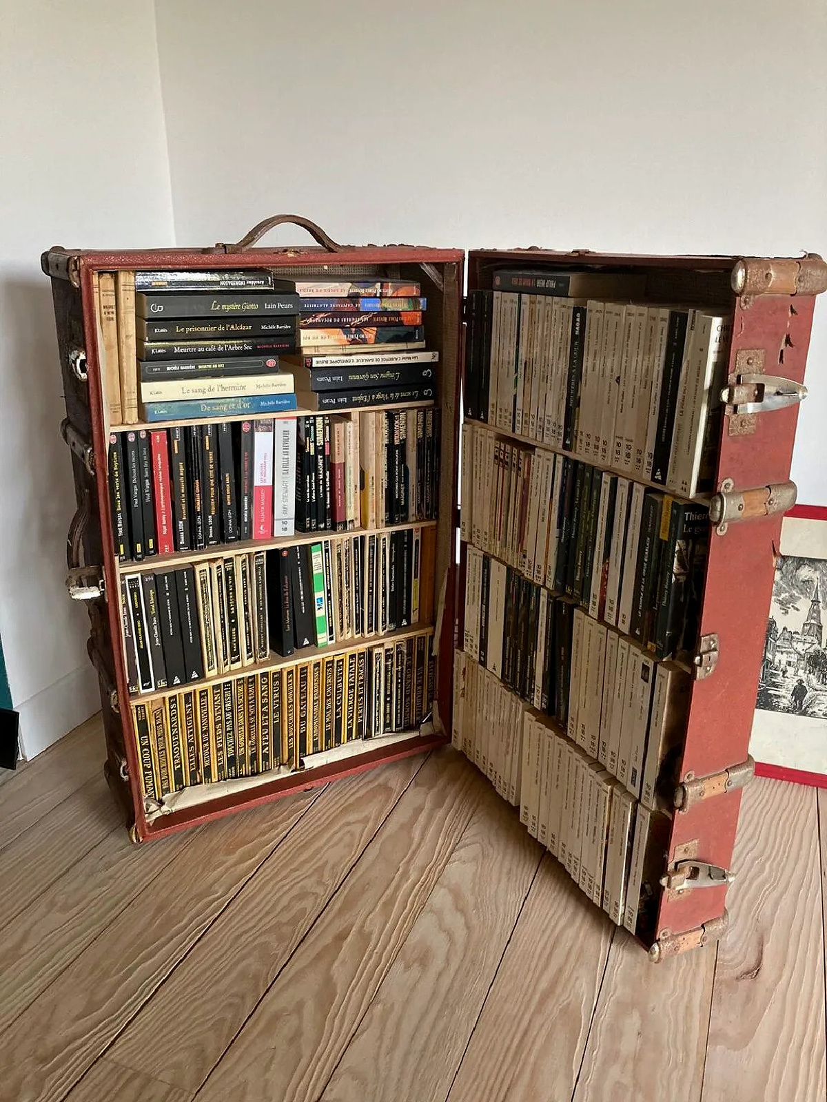 CDs in an opened suitcase turned bookshelf.