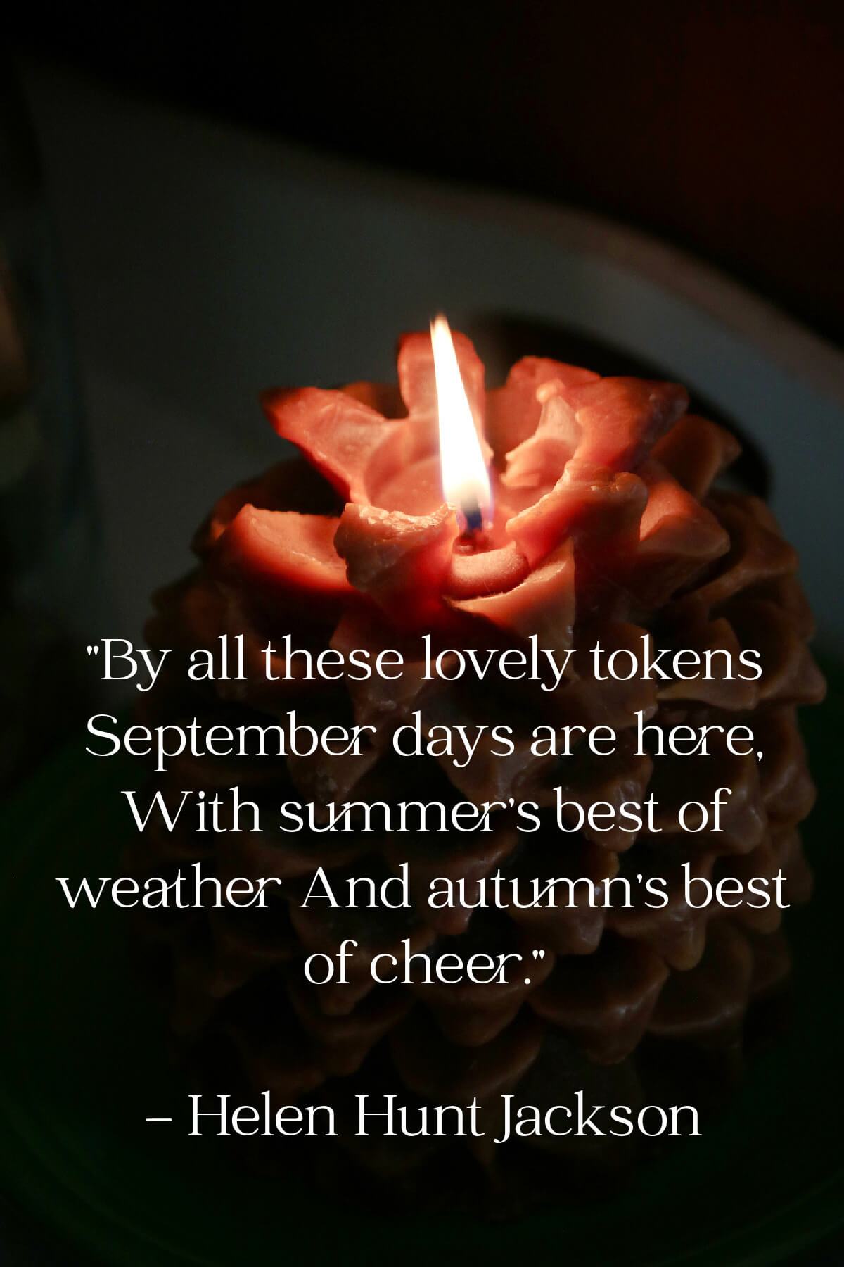 A rust colored fall candle shaped like an acorn.
