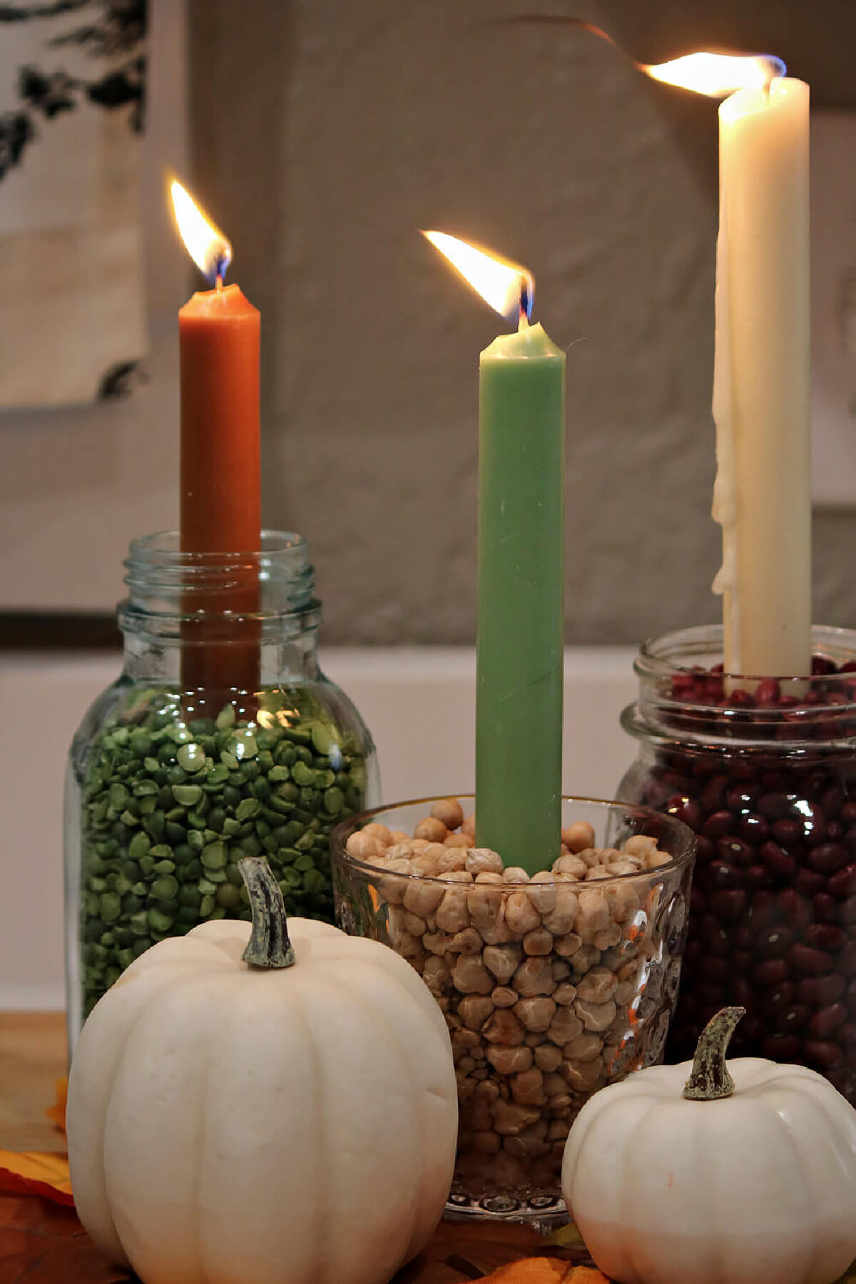 DIY fall candle display I created with peas and beans, and a couple of faux beige pumpkins.