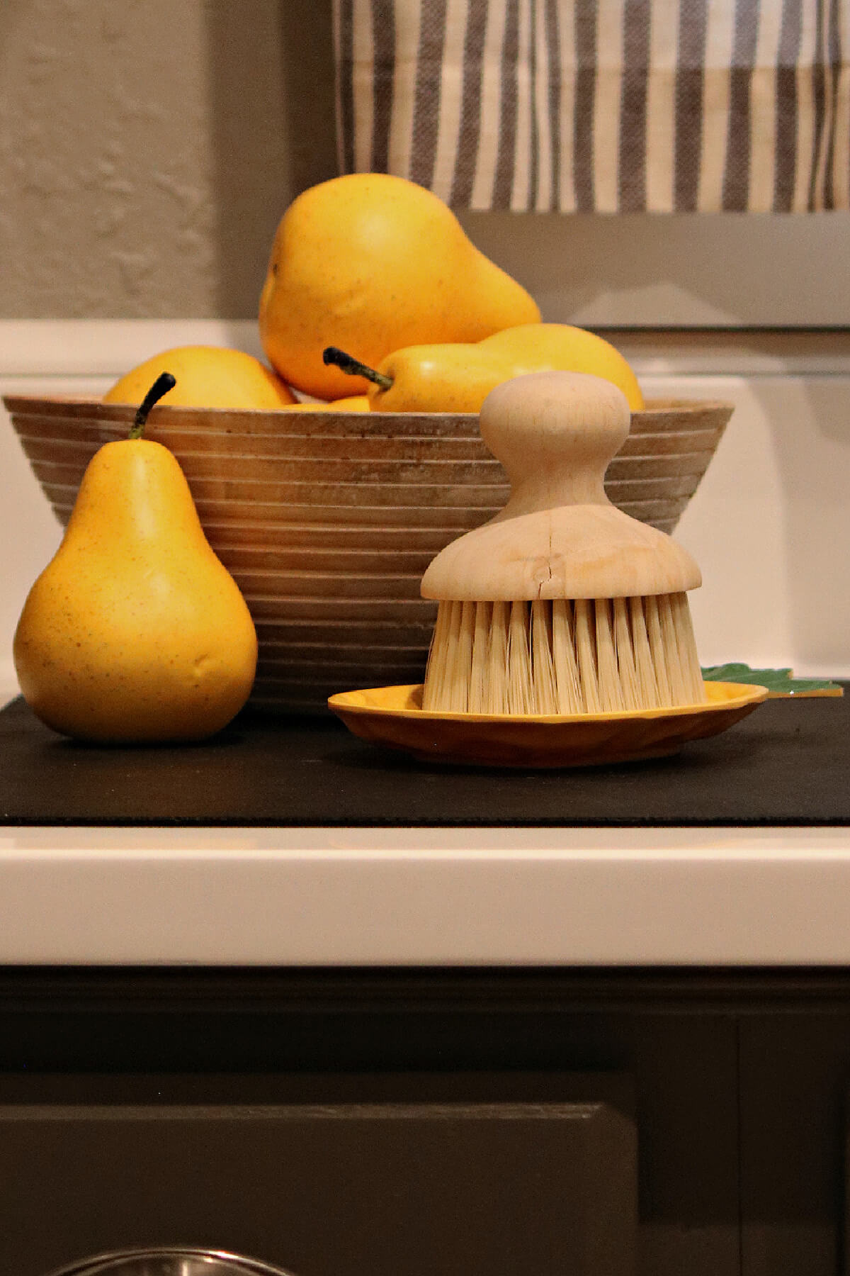 The rich colors of fall in my kitchen include these golden faux pears in a wooden bowl.