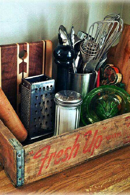 A soda crate with various vintage decor tucked inside.