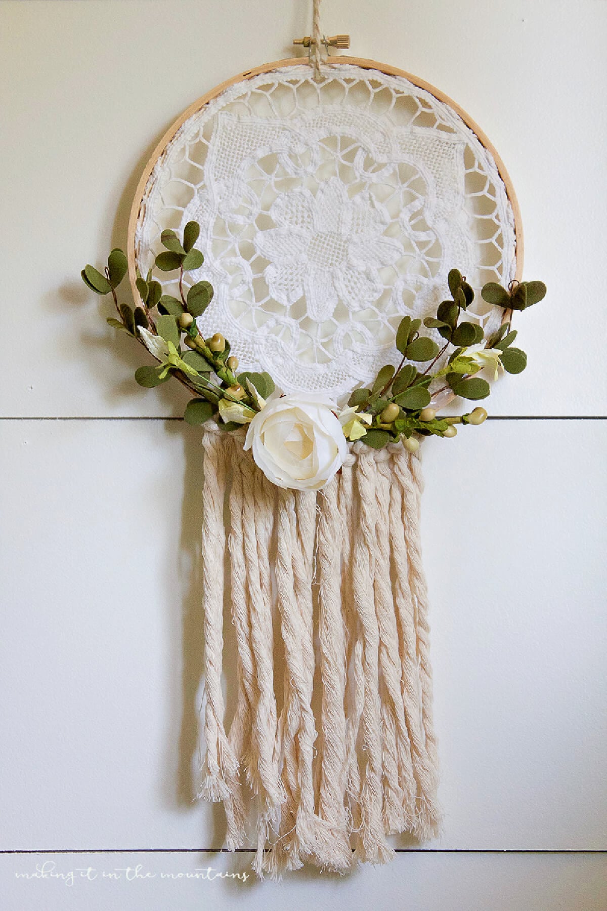 Clever DIYs with crocheted doilies include this lovely dream catcher with flowers.