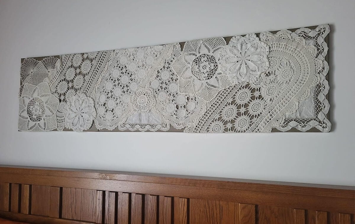 Clever DIYs with crocheted doilies created this gorgeous wall art.
