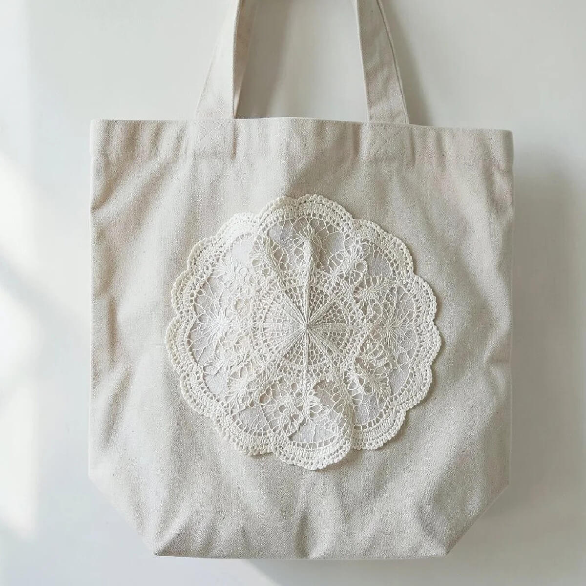 Clever DIYs with crocheted doilies include adding them to canvas bags.