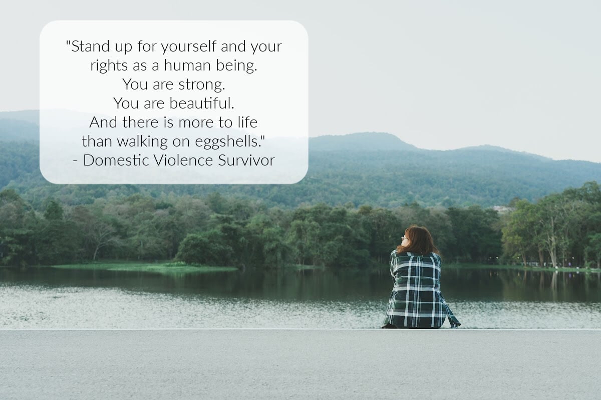 She is sitting by the water looking out over the mountains.